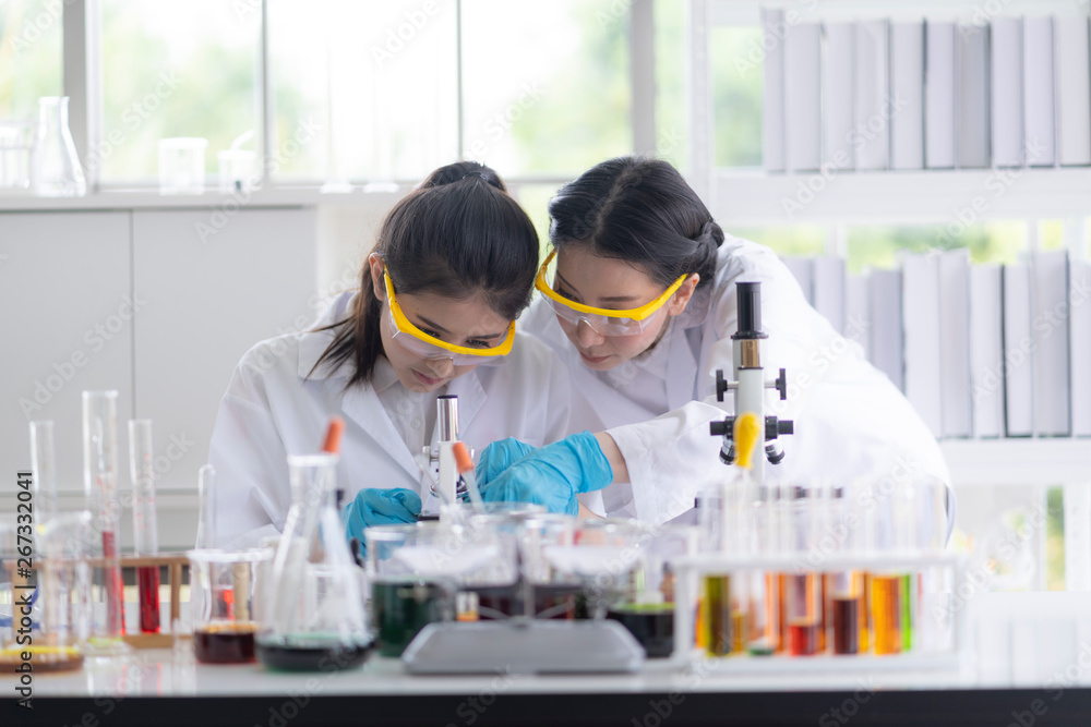 Female scientists are preparing microscopes for testing and analysis through an extension to find the results of medical research. Scientific and chemical concepts Female scientists are preparing microscopes for testing and analysis through an extension to find the results of medical research. Scientific and chemical concepts