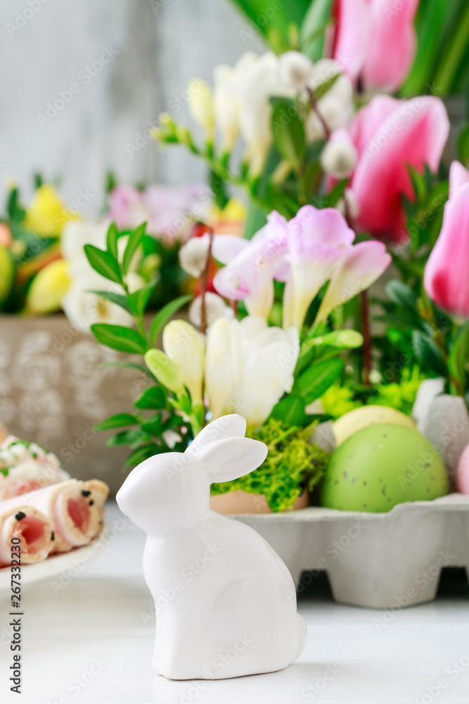 Ceramic rabbit figure on Easter table.