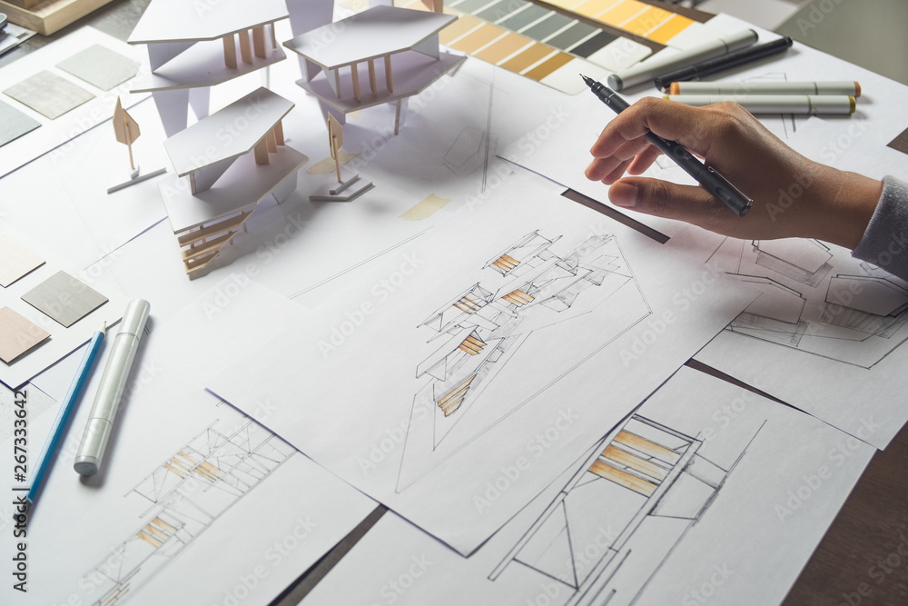 Professional architect working on blueprints and construction plans.  Building engineers calculate and draft building construction drawings,  civil engineering, and construction business concepts. - Stock Image -  Everypixel