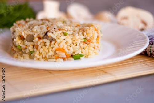 White plate with spicy pilaf with mushrooms