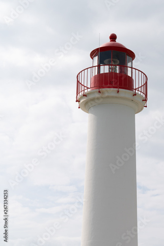 red and white lighthouse for boat in cloud sky vertical