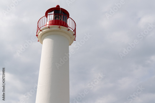 lighthouse for boat red and white in cloud sky