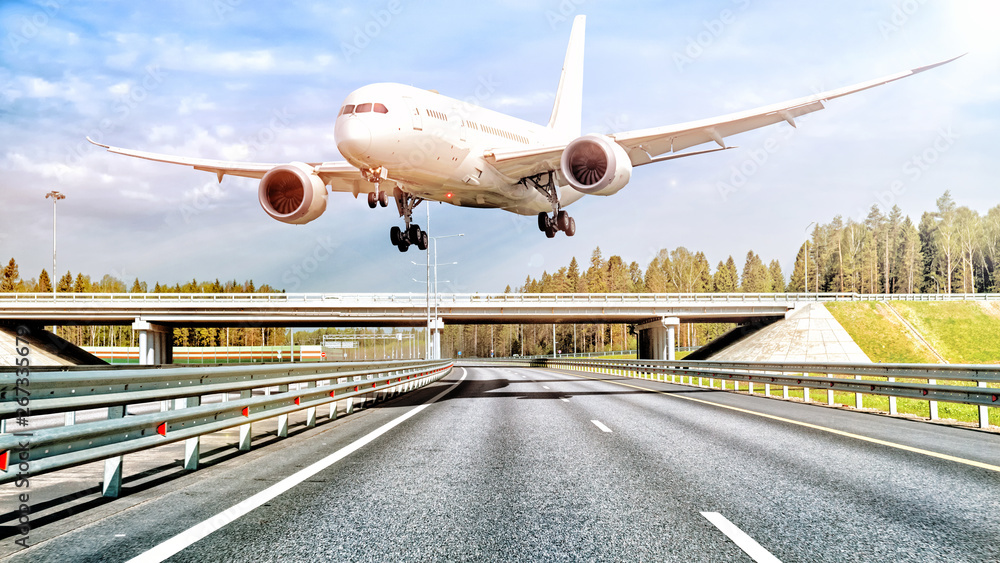 modern airplane flying low over freeway to airport driver person road