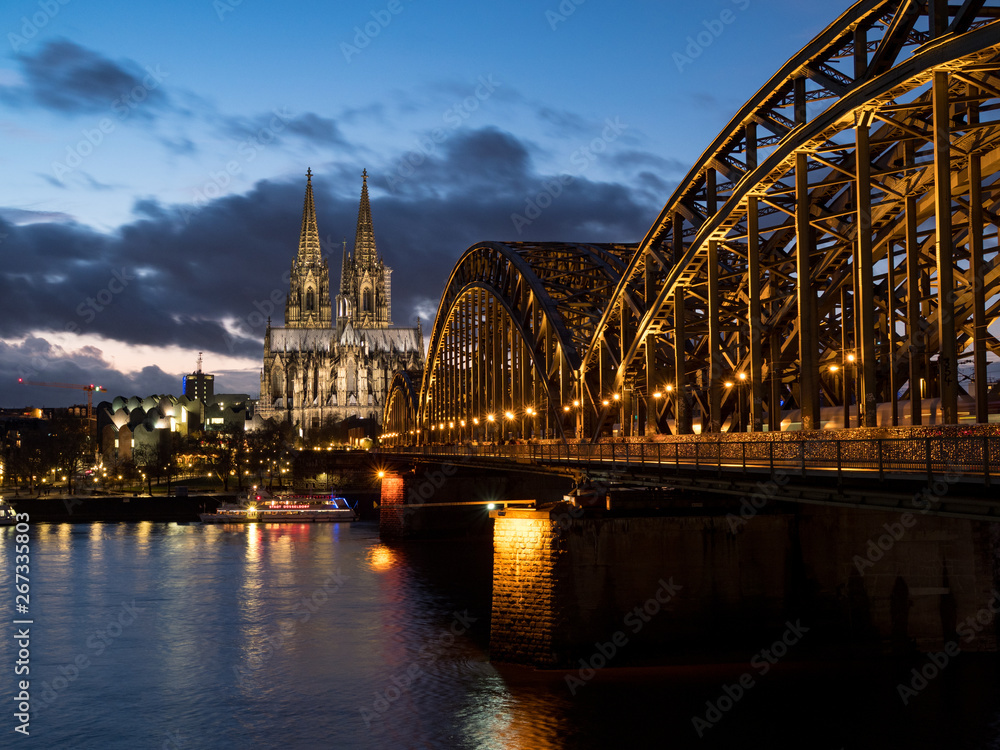Naklejka premium December, 2018: Night view of Hohenzollern Bridge and the cathedral in Cologne, Germany