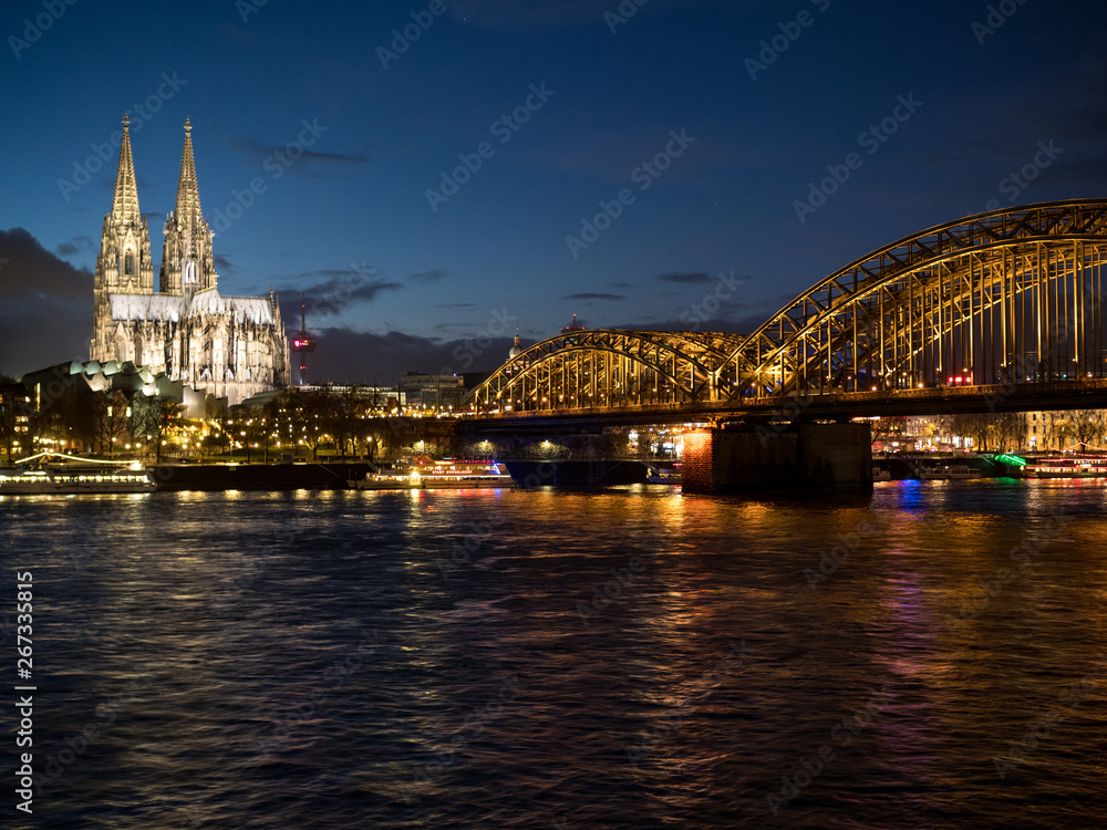 December, 2018: Night view of Hohenzollern Bridge and the cathedral in Cologne, Germany