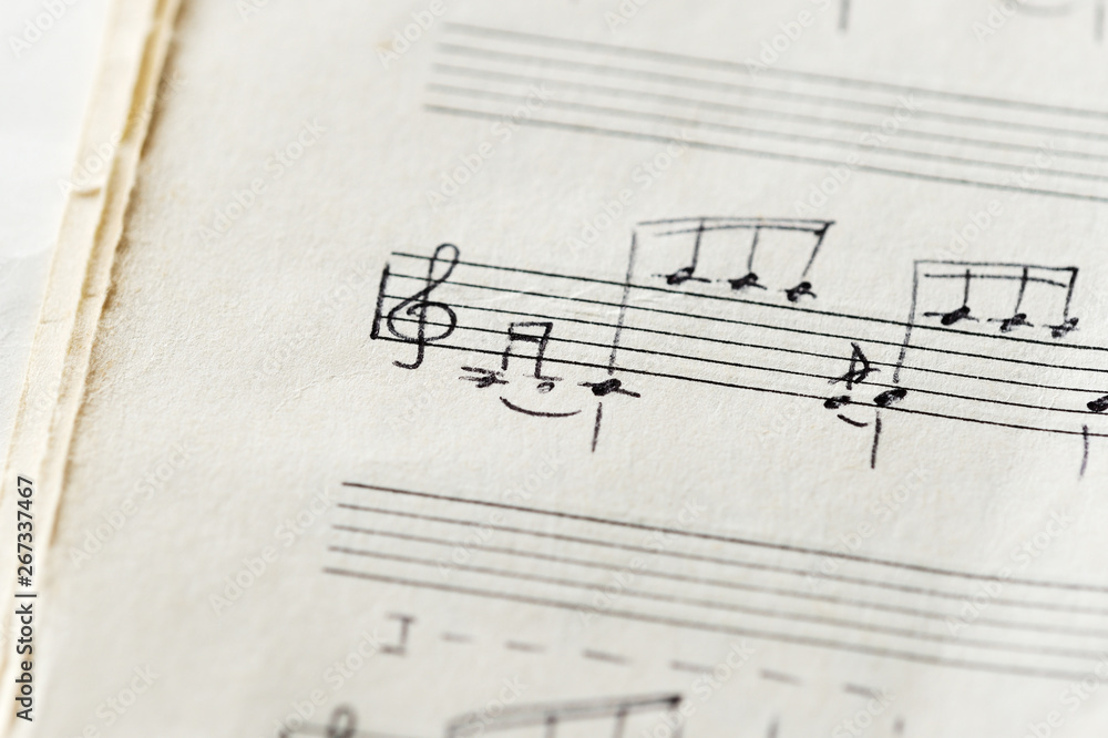 Fragment of an old musical notebook with hand written notes close up Fragment of an old musical notebook with hand written notes close up