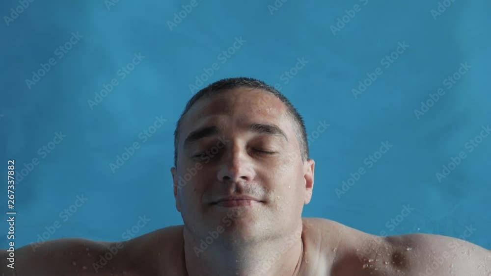 Man immersed in clean water in the pool. Man immersed in clean water in the pool.