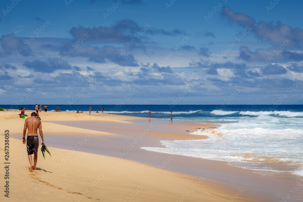 People enjoying a beautiful sandy beach and surf at Oahu, Hawaii in May 2015