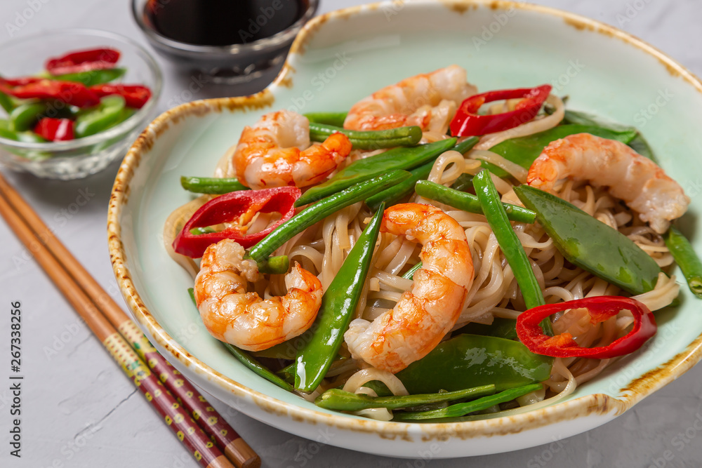 Asian dish of fried rice noodles with shrimp and vegetables Asian dish of fried rice noodles with shrimp and vegetables