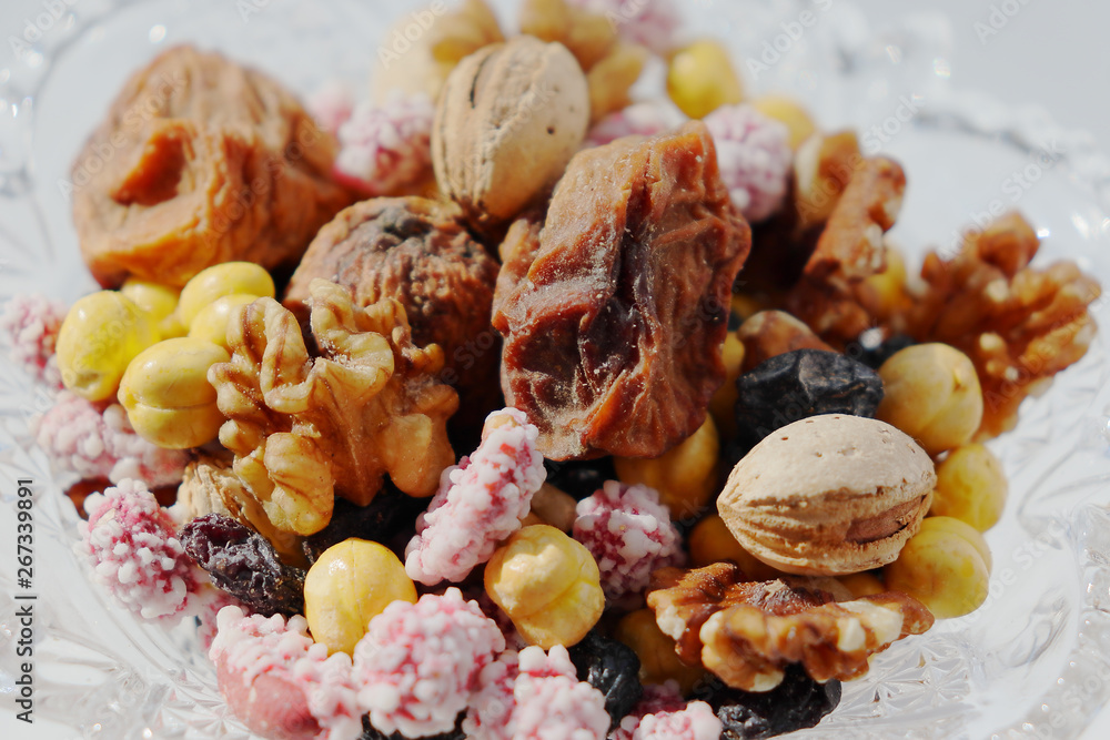 Sweet dried fruits and nuts in a crystal vase. Sweet dried fruits and nuts in a crystal vase.