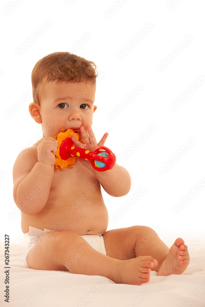 Hapy baby boy in playing on bed isolated over white Hapy baby boy in playing on bed isolated over white