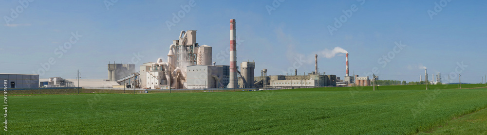 Panorama of the plant of building materials, sunny spring day
