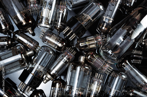 Electronic vacuum tubes on the dark mirror background. Old electronic radio components. 