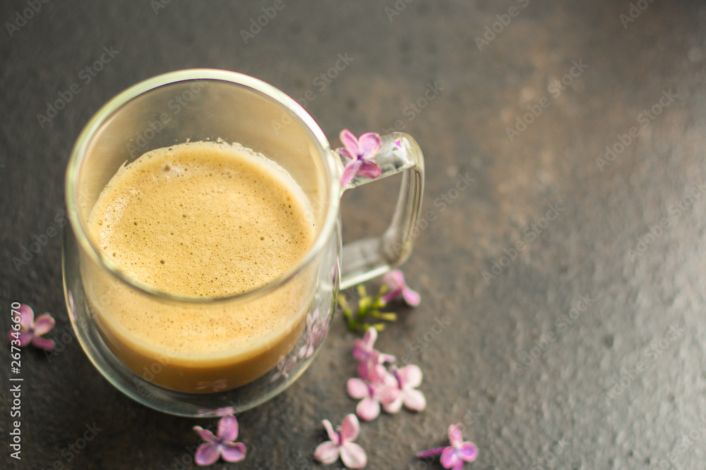 coffee with milk (cappuccino or latte) flavored drink in a transparent cup. food background. top coffee with milk (cappuccino or latte) flavored drink in a transparent cup. food background. top