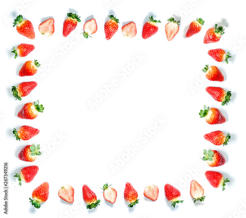 Frame of ripe fresh strawberries with green leaves isolated on a white background with space for text.