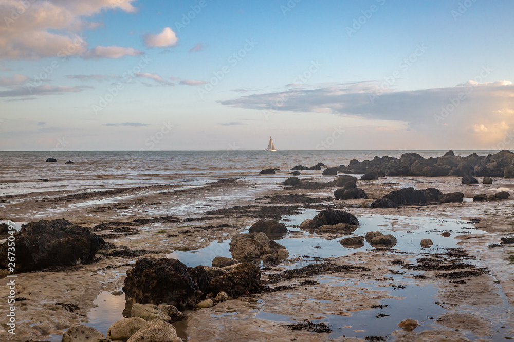 Looking out to sea over a rocky beach at low tide, near Eastbourne in Sussex