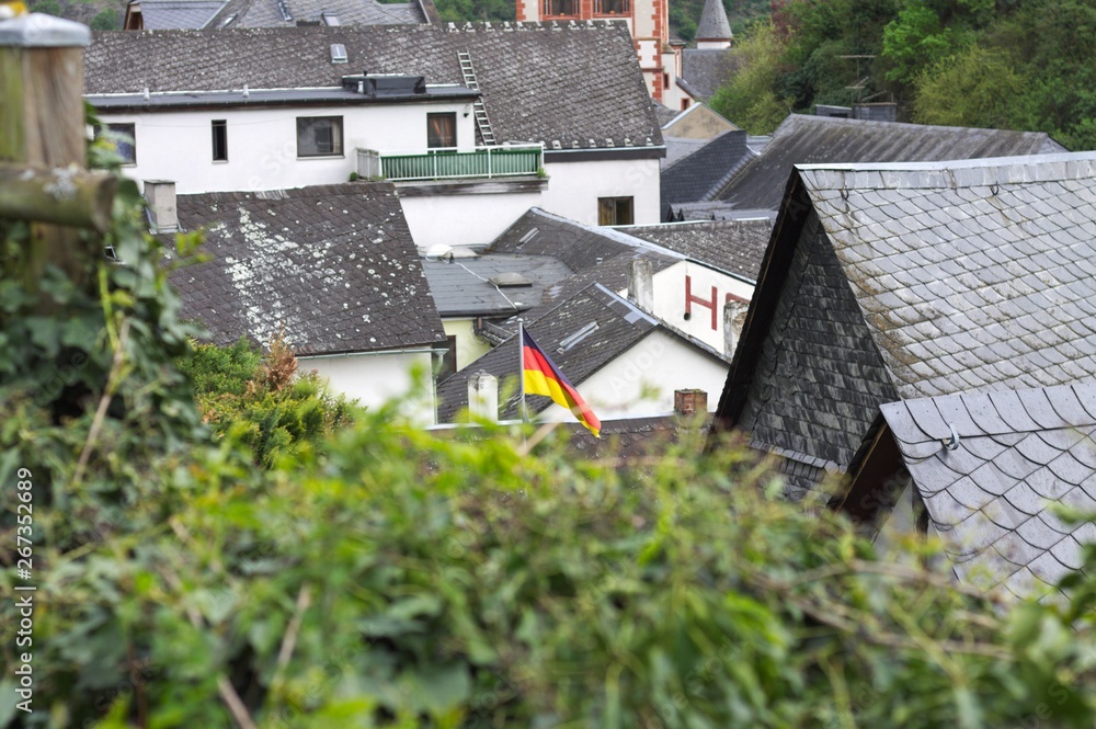 German flag above the roofs of Bacharach (Germany, Europe)