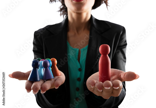 Business woman holds wooden toy shaped as person. Concept of business teamwork and leadership. Isolated on white background