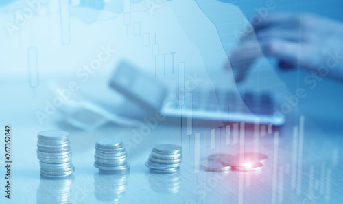 Double exposure of financial graph chart and rows of coins with calculator for finance and business concept
