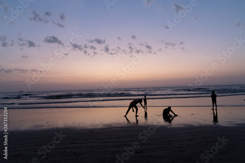 Silhouette of young boy performing stunts in front of sea © Jimmy Shroff