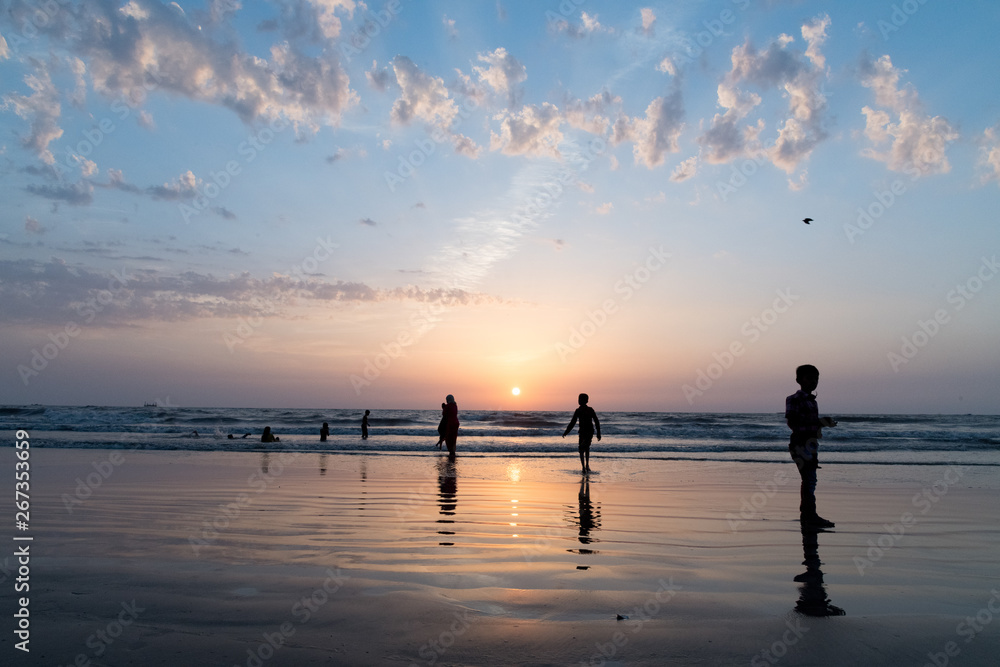 Silhouettes of people playing on Juhu beach