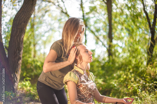 Woman masseuse impliments her massage abilities in nature. photo