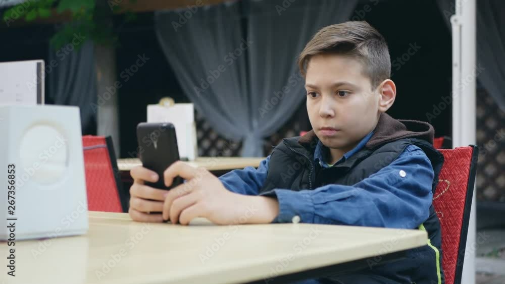 A bored guy dissatisfied scrolls the news line in social networks, an application for smartphones A bored guy dissatisfied scrolls the news line in social networks, an application for smartphones