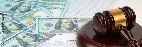 Law concept or auction concept. Dollar bills , judge's gavel on white background. closeup of a gavel on cash, from above.