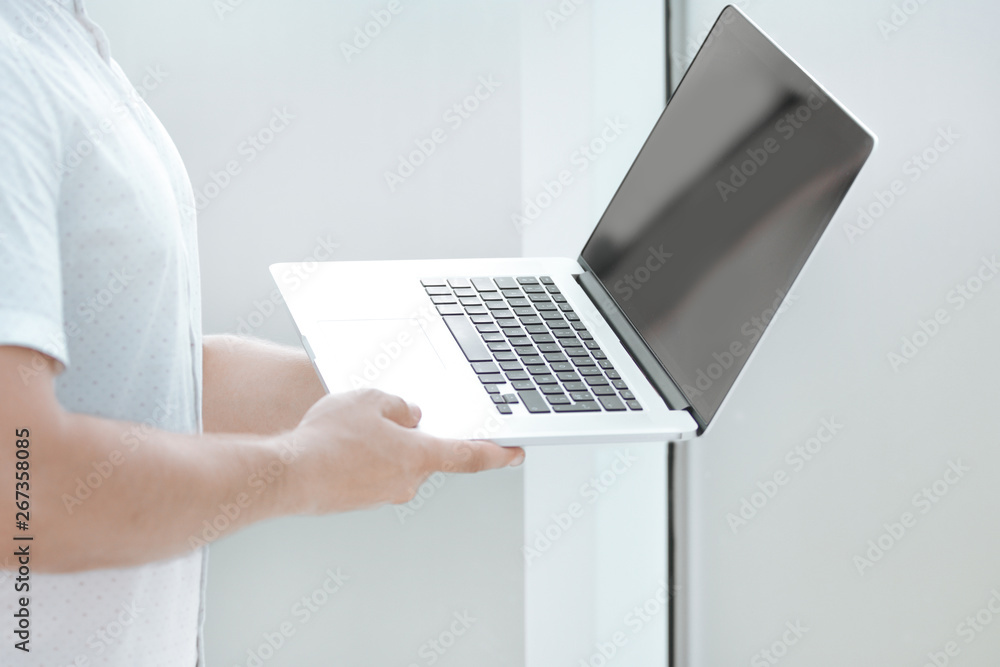 close up. businessman with laptop standing in the office. close up. businessman with laptop standing in the office.