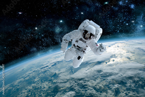 Fototapeta Photo of astronaut in space, in background planet earth