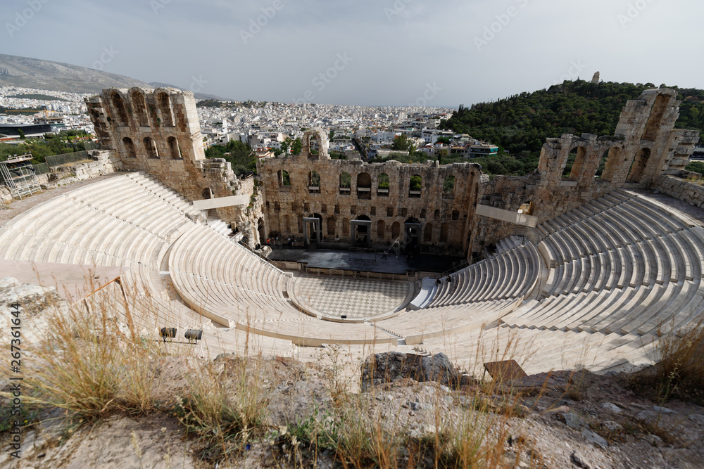 View into historic Odeon of Herodes Atticus situated in the Acropolis of Athens with view of the city (Athens, Greece, Europe)