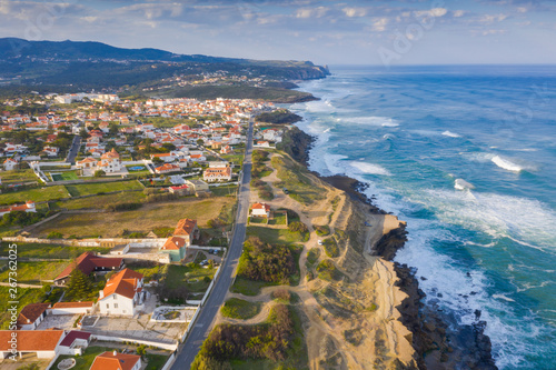 Aerial view of small town with red roofs on coastline Atlantic ocean. Top View of Azenhas Do Mar, Sintra, Portugal