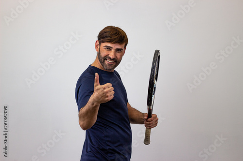 Portrait of handsome young man playing tennis holding a racket with brown hair clapping hands, their back facing the camera and looking at the camera. Isolated on white background.