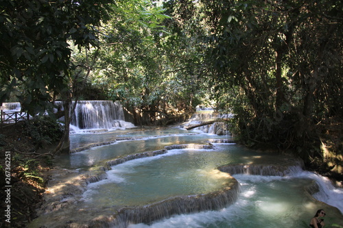 Fototapeta Naklejka Na Ścianę i Meble -  Scenic view on cascades and natural blue pool of idyllic Kuang Si waterfalls in jungle near Luang Prabang, Laos