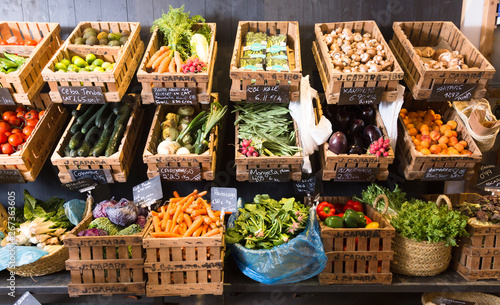 Fototapeta Naklejka Na Ścianę i Meble -  vegetables and fruits in wicker baskets in greengrocery
