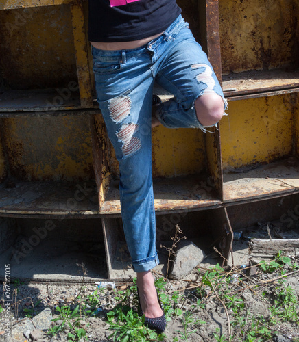 Woman in ragged jeans