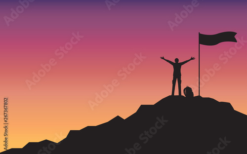 Silhouette happy man raising hand standing on top of mountain