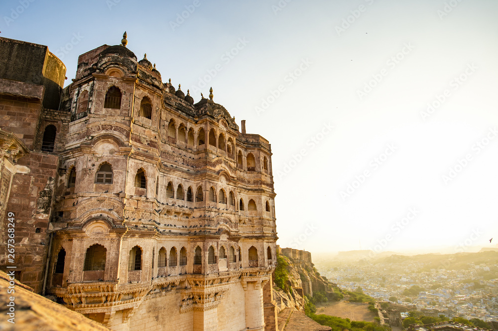 Stunning view of the ancient Mehrangarh Fort during a beautiful sunset with the blue city of Jodhpur in the background, Rajasthan, India. Mehrangarh (Mehran Fort) is one of the largest forts in India.