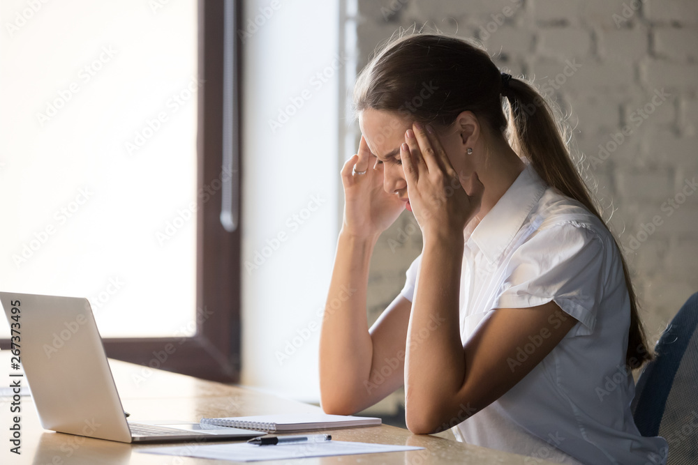 Businesswoman touch temples suffer from headache at work Businesswoman touch temples suffer from headache at work