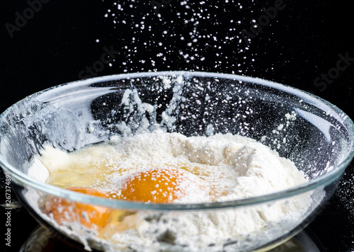 Add eggs and flour to a transparent bowl for making batter.