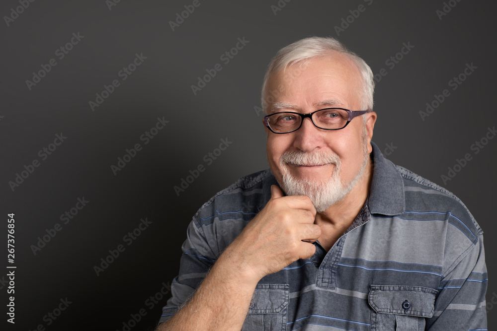 an adult, white-haired man with glasses smiles good-naturedly an adult, white-haired man with glasses smiles good-naturedly