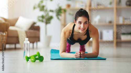 young woman doing fitness and sports at home