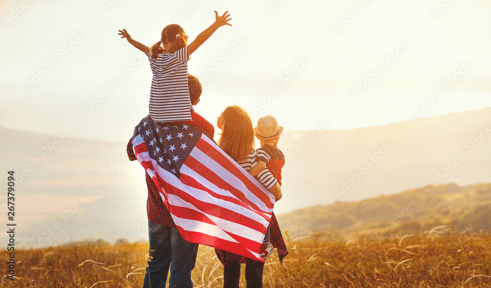happy family with flag of america USA at sunset outdoors. - obrazy, fototapety, plakaty 