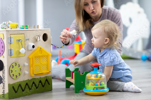Cute toddler baby playing w...
