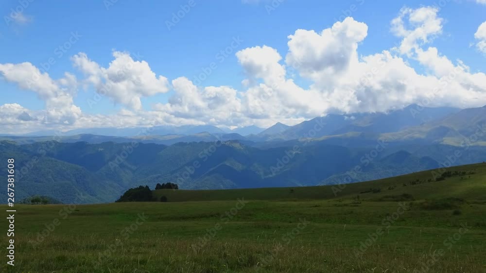 Time lapse mountains scene in national park of Dombay, Caucasus, Russia, Europe. Summer landscape, sunshine weather, blue sky and sunny day Time lapse mountains scene in national park of Dombay, Caucasus, Russia, Europe. Summer landscape, sunshine weather, blue sky and sunny day