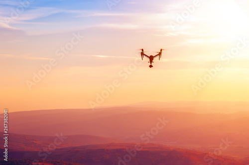 Drone flying over the hills in the sunset