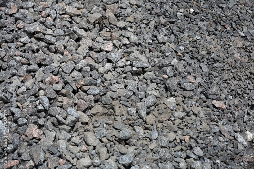 Gray textured surface of a heap of construction pebbles and gravel Gray textured surface of a heap of construction pebbles and gravel