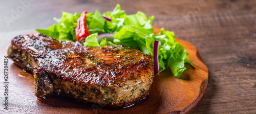Obraz na plátně Pork Loin chops marinated meat Steak with vegetables slad on wooden table backgr