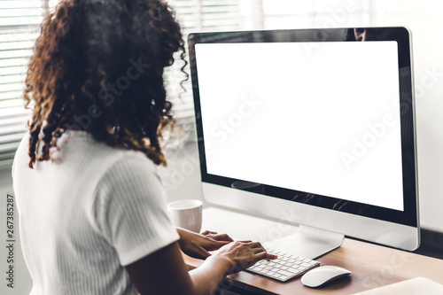 African american black woman using computer with white mockup blank screens in modern work loft