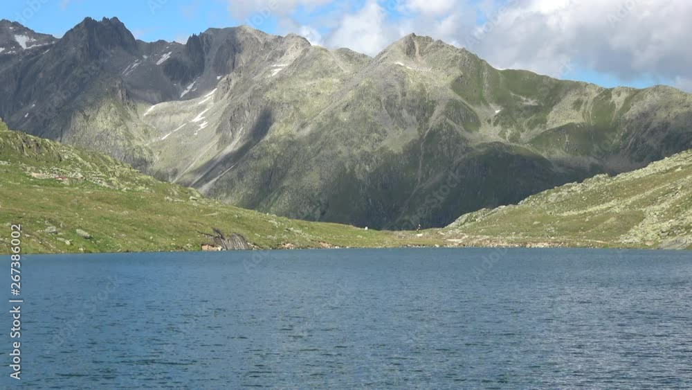 Scenic view on peak of mountains and lake in Swiss Alps. Summer landscape, sunshine weather, blue sky and sunny day Scenic view on peak of mountains and lake in Swiss Alps. Summer landscape, sunshine weather, blue sky and sunny day